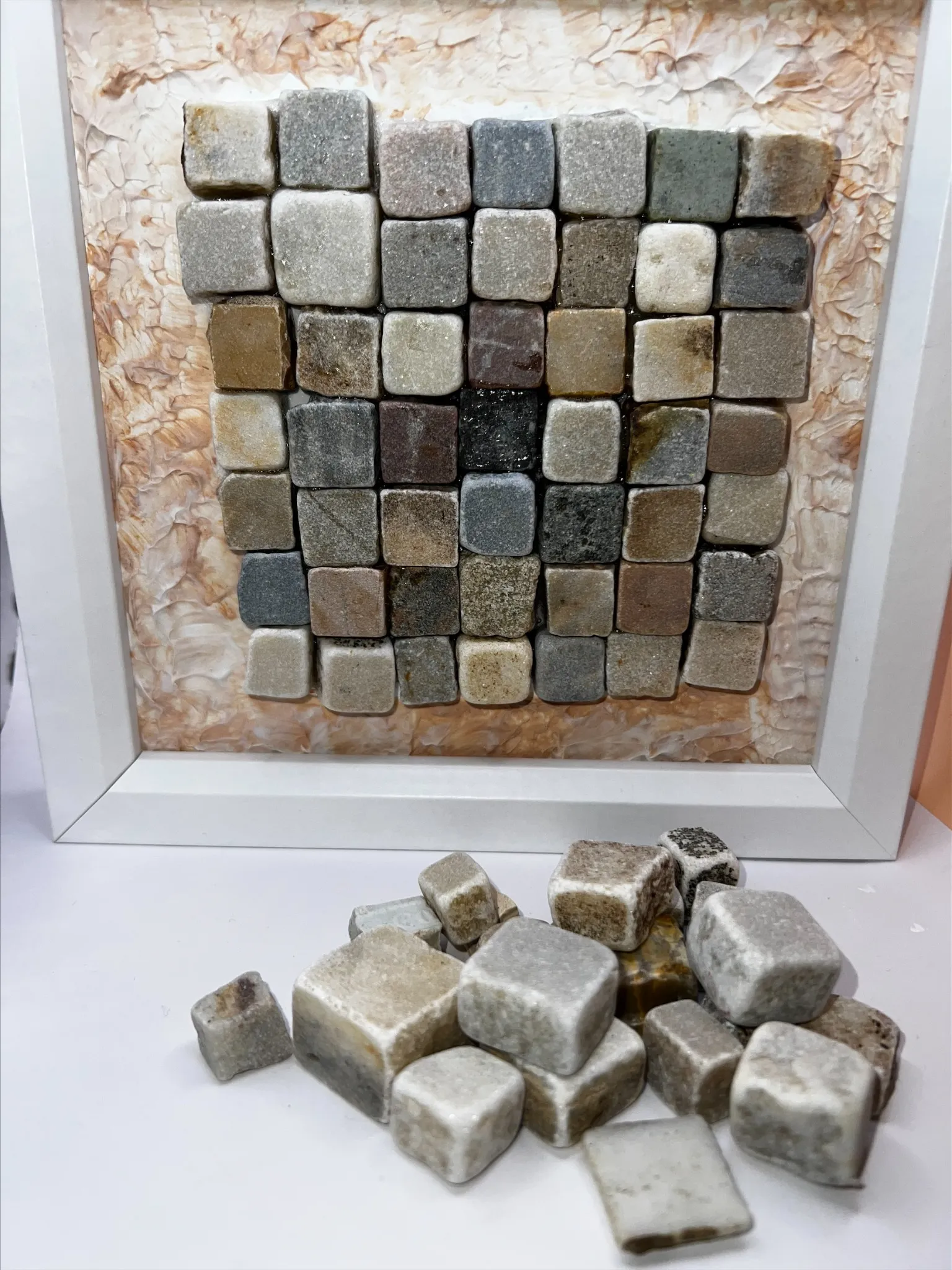 Framed grid of grey and brown fragments with contrasting textures