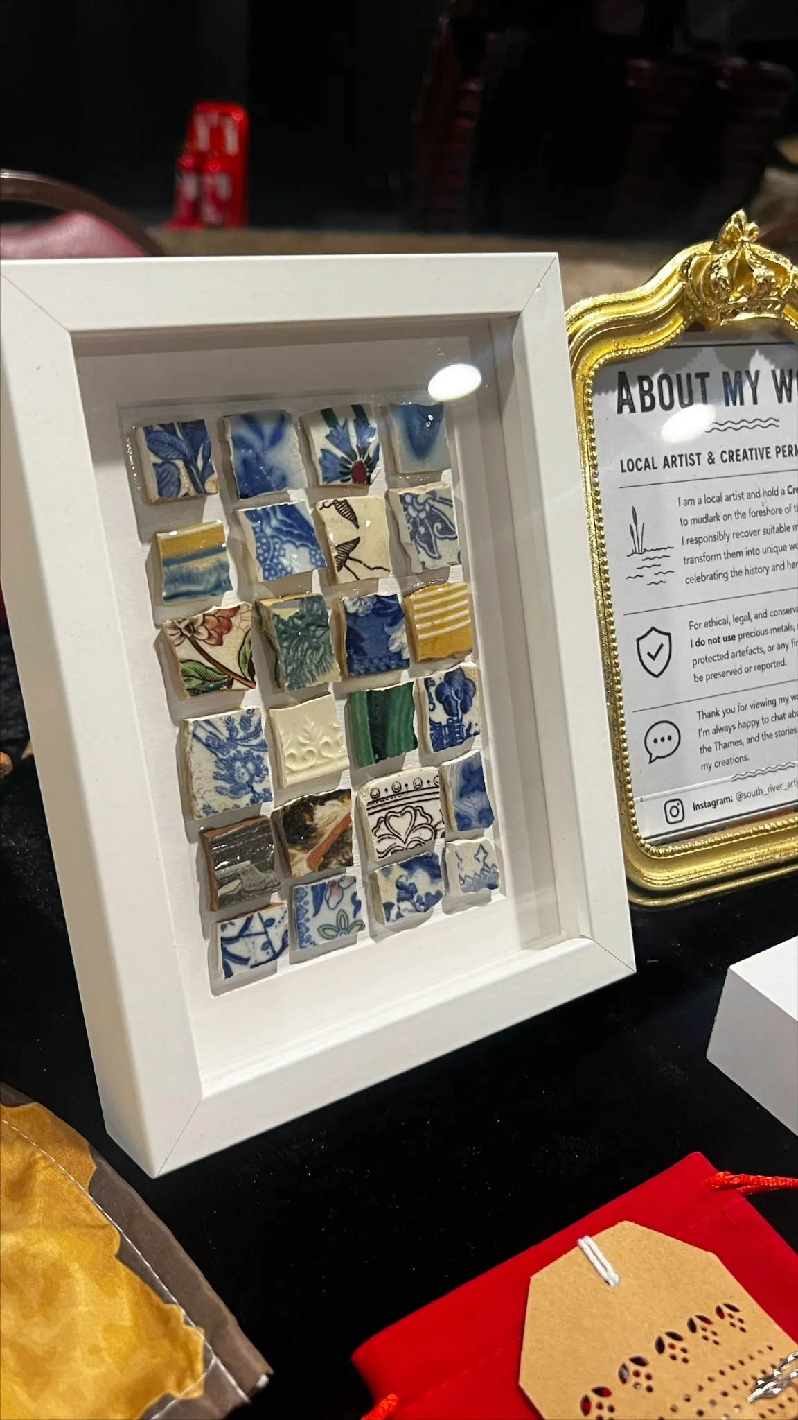 Pottery sherds with varied colours and patterns arranged in a white frame